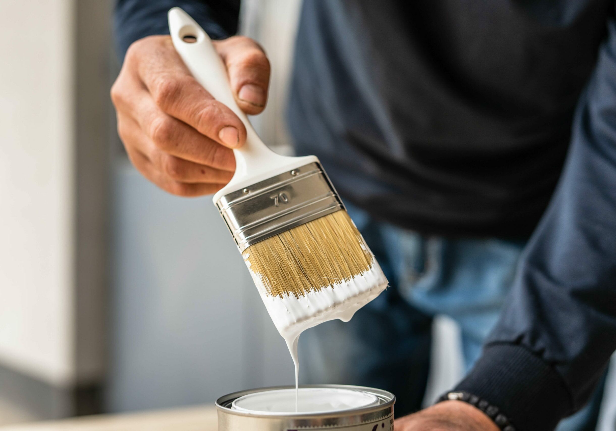 painter cleaning a paint brush